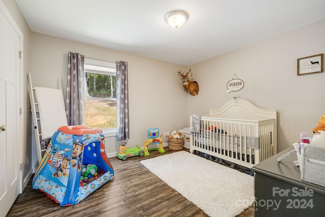 bedroom featuring baseboards and wood finished floors