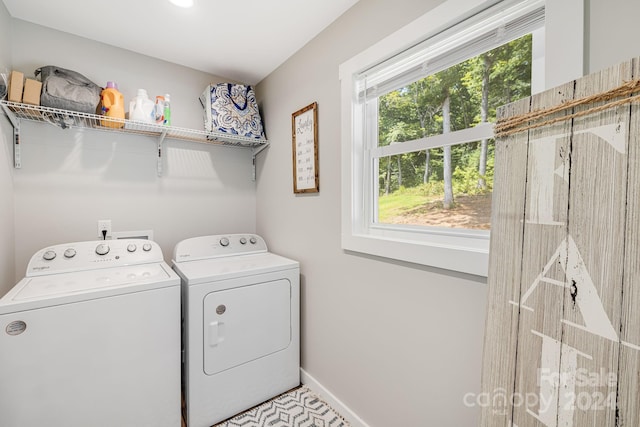 laundry area featuring laundry area, separate washer and dryer, and baseboards