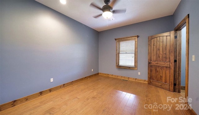 unfurnished room with ceiling fan and light wood-type flooring