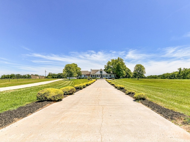 view of property's community with a yard and a rural view