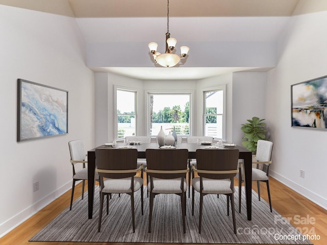 dining space featuring hardwood / wood-style flooring and a notable chandelier