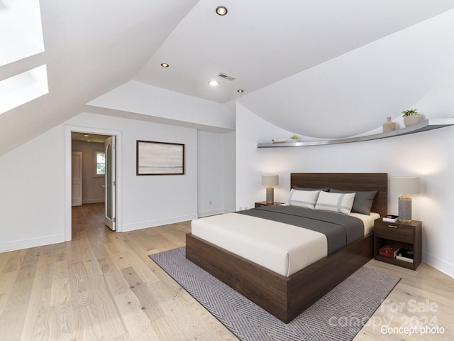 bedroom with vaulted ceiling and light hardwood / wood-style flooring