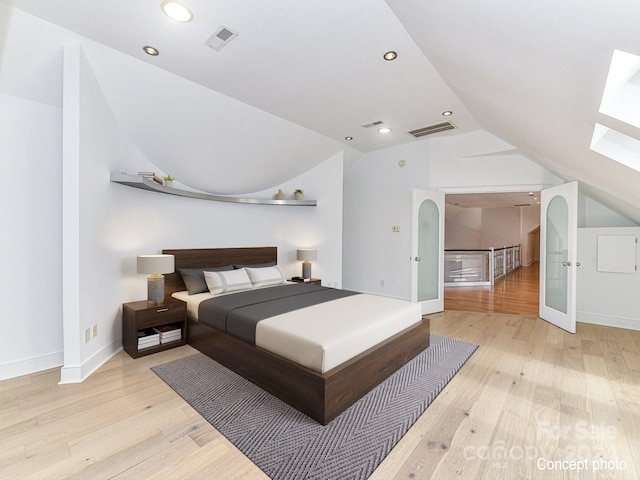 bedroom featuring vaulted ceiling and light hardwood / wood-style flooring