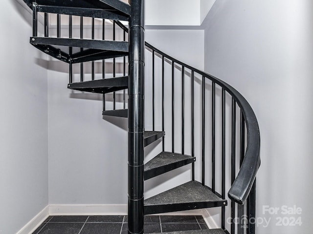 staircase featuring tile patterned floors