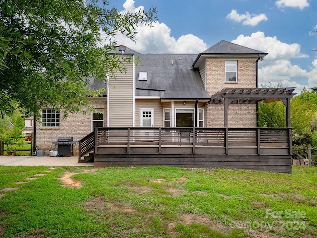 back of house with a yard, a pergola, and a deck