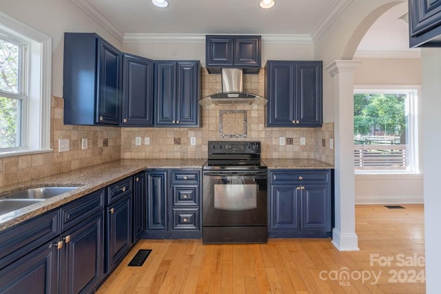 kitchen featuring a wealth of natural light, black electric range oven, and light wood-type flooring