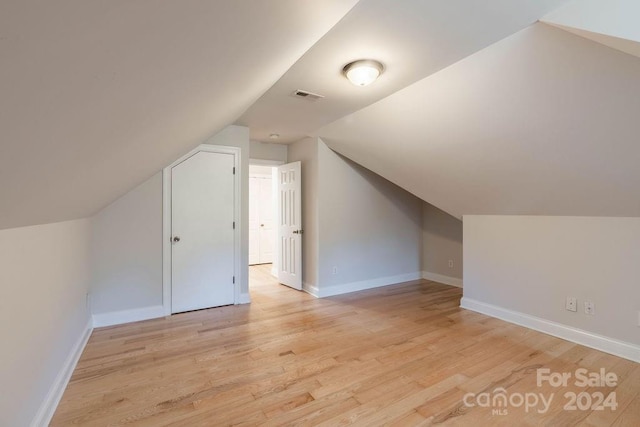 bonus room featuring light hardwood / wood-style floors and vaulted ceiling