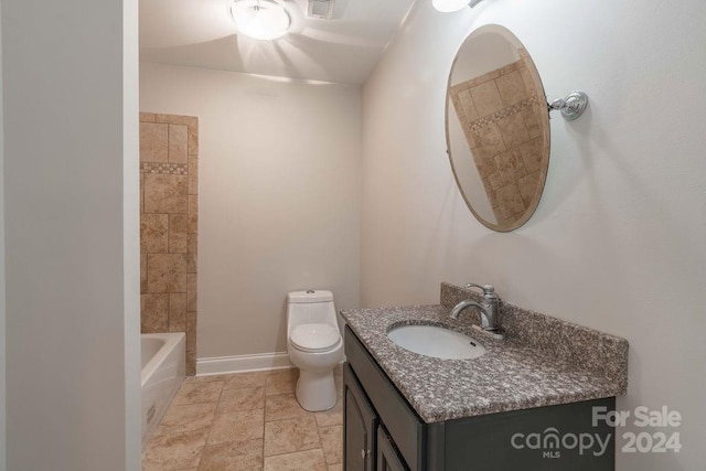 full bathroom with tiled shower / bath, vanity, and toilet