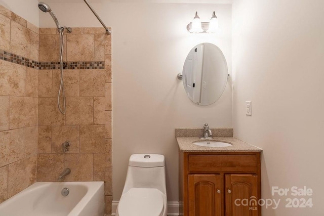 full bathroom featuring toilet, vanity, and tiled shower / bath