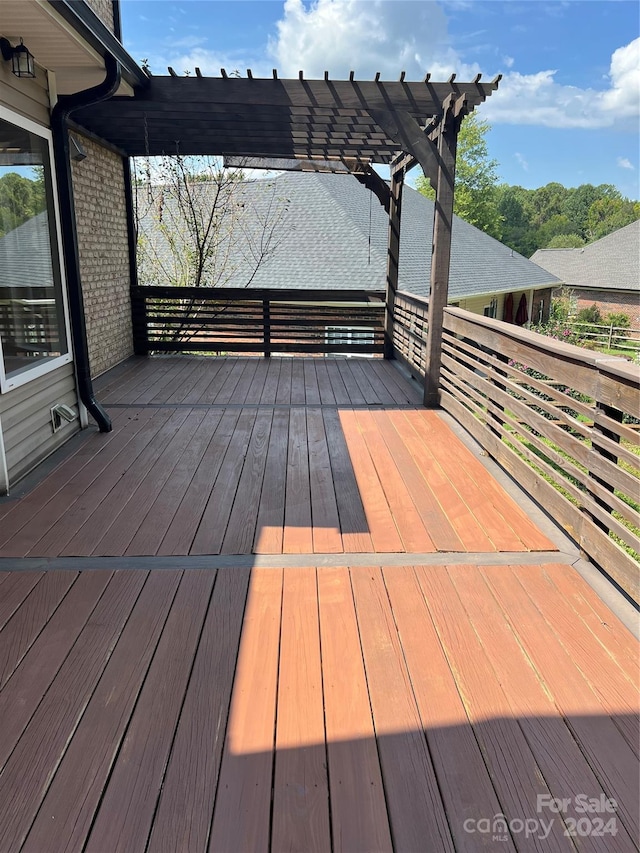 wooden deck featuring a pergola