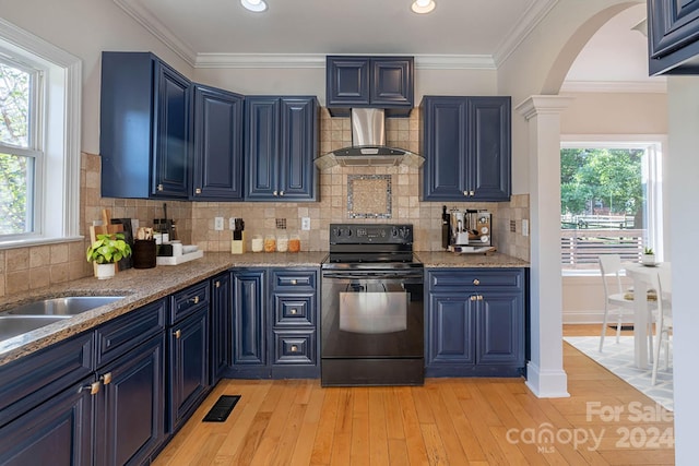 kitchen featuring blue cabinetry, black / electric stove, a wealth of natural light, and light hardwood / wood-style flooring