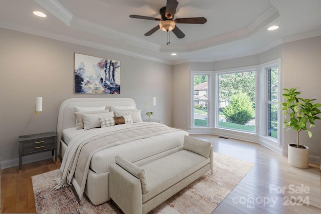 bedroom featuring ceiling fan, light hardwood / wood-style flooring, and ornamental molding