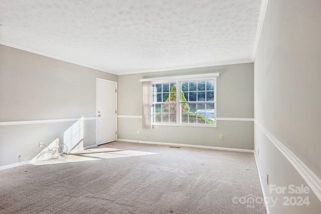 unfurnished room featuring crown molding, a textured ceiling, and carpet flooring