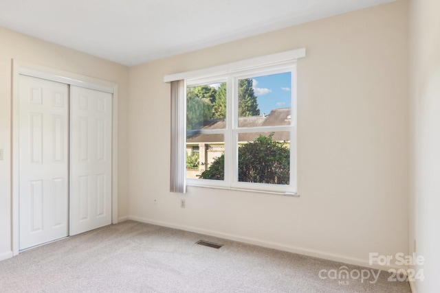 unfurnished bedroom with a closet and carpet floors