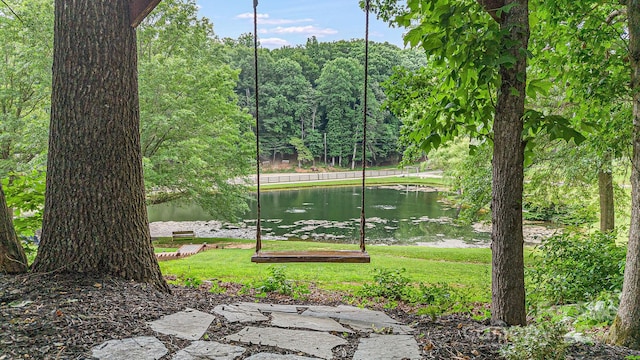 view of community featuring a water view and a lawn