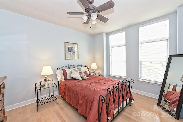 bedroom with ceiling fan and light hardwood / wood-style flooring