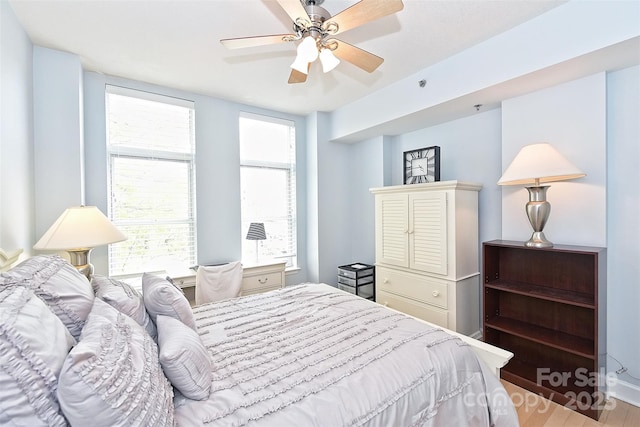 bedroom featuring ceiling fan and hardwood / wood-style floors