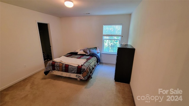 bedroom featuring carpet floors, visible vents, and baseboards