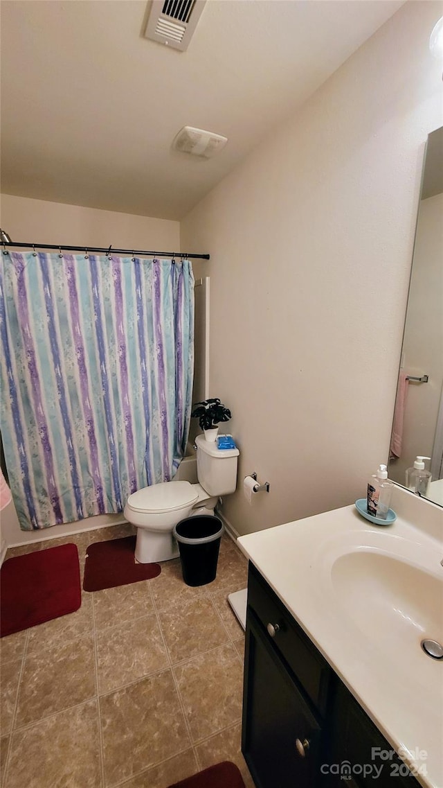 bathroom with shower / tub combo, visible vents, toilet, tile patterned floors, and vanity