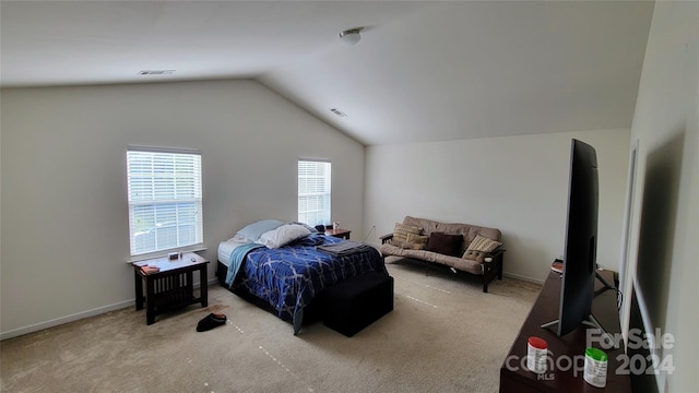 carpeted bedroom featuring lofted ceiling, baseboards, and visible vents