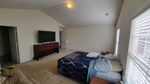 bedroom featuring lofted ceiling, light carpet, visible vents, and baseboards