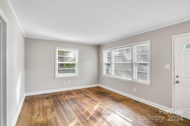 entryway with hardwood / wood-style flooring and ornamental molding