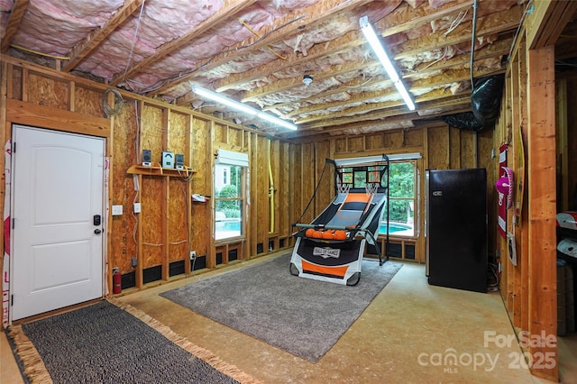 garage featuring stainless steel refrigerator