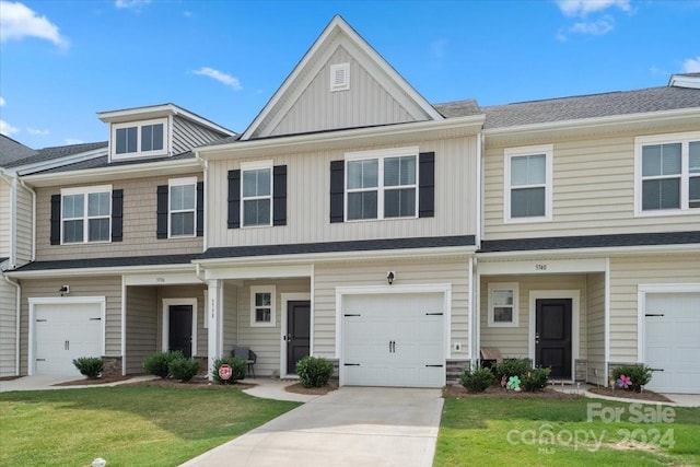 view of property with a garage and a front yard