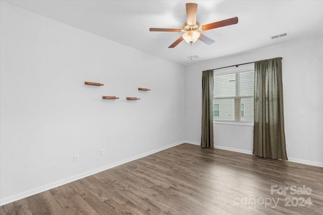 empty room featuring ceiling fan and hardwood / wood-style floors