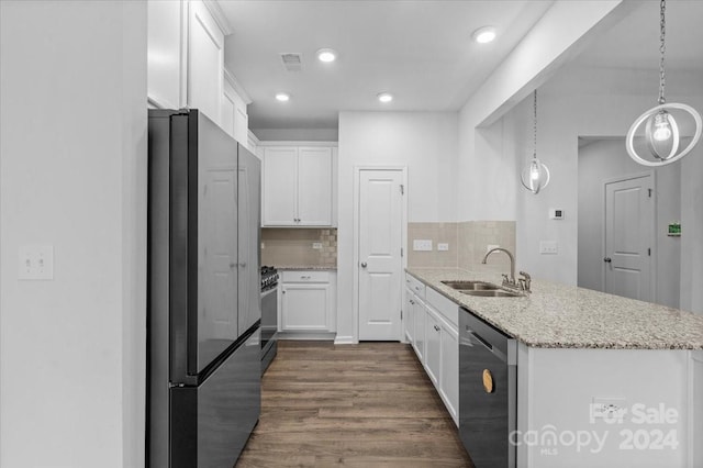 kitchen featuring appliances with stainless steel finishes, decorative backsplash, white cabinets, and sink