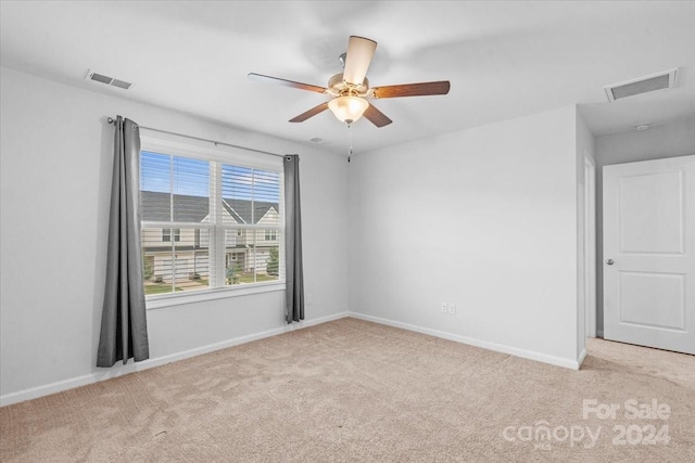 carpeted empty room with ceiling fan