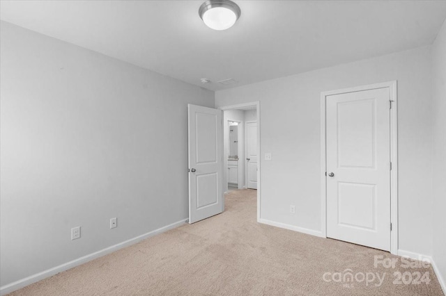 unfurnished bedroom with light carpet