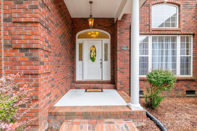 view of exterior entry with a porch