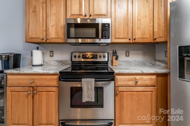 kitchen with light stone counters and stainless steel appliances