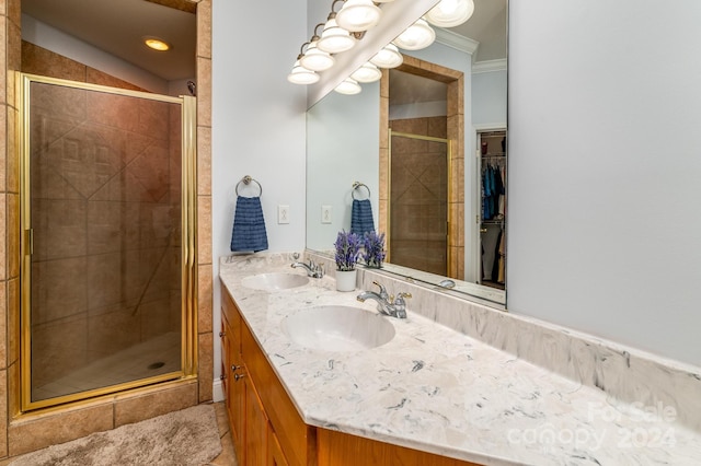 bathroom with crown molding, vanity, and a shower with door