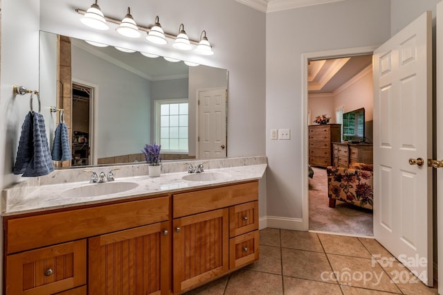 bathroom with tile patterned flooring, ornamental molding, and vanity