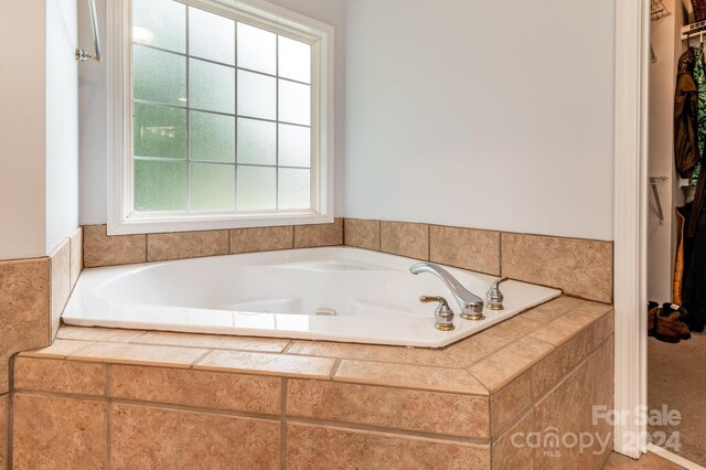 bathroom with tiled bath