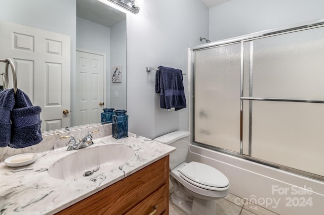 full bathroom with vanity, toilet, and combined bath / shower with glass door