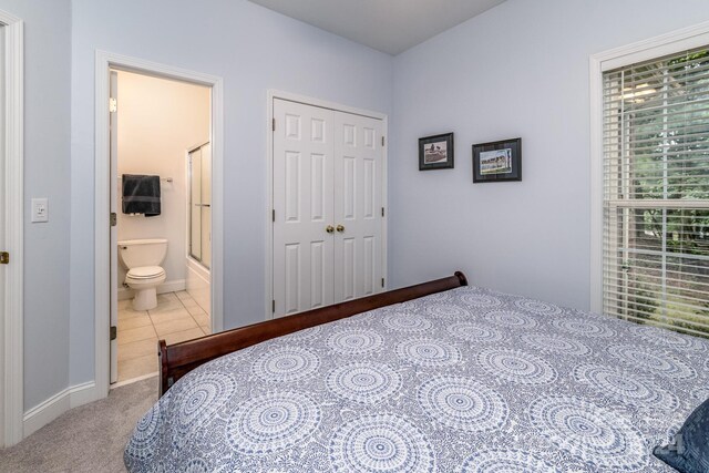 carpeted bedroom with ensuite bath