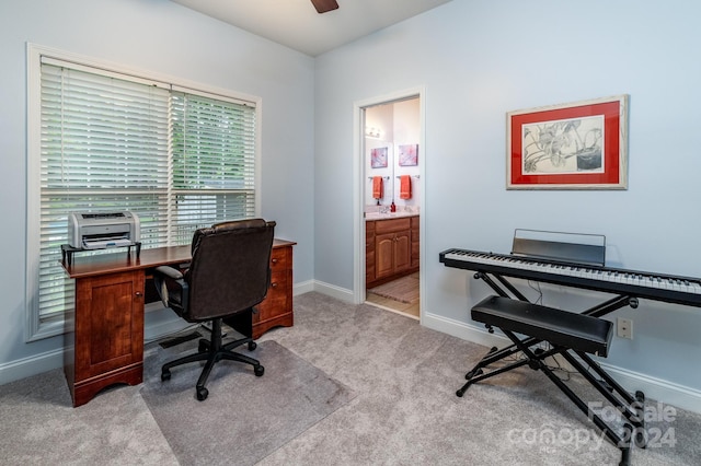 office area featuring light colored carpet and ceiling fan