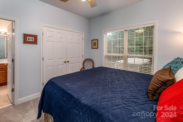 bedroom with carpet flooring, a closet, ceiling fan, and ensuite bathroom