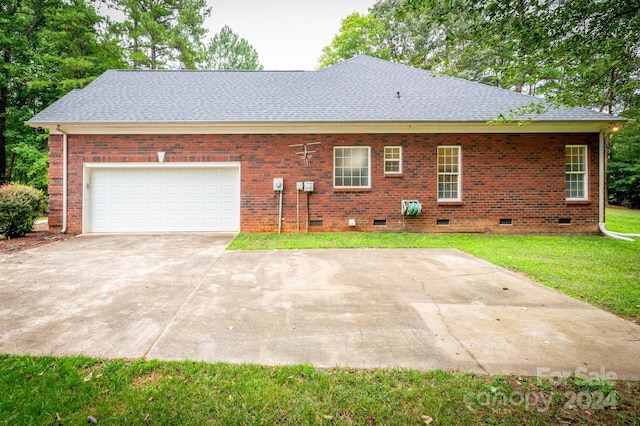 exterior space featuring a garage and a yard