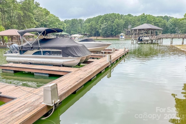 view of dock featuring a gazebo and a water view