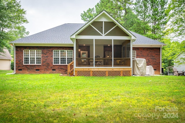 back of property with a lawn and a sunroom