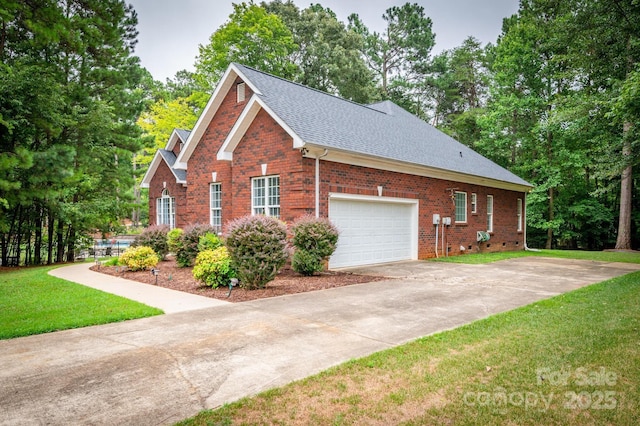 view of property exterior featuring a lawn, brick siding, roof with shingles, and concrete driveway
