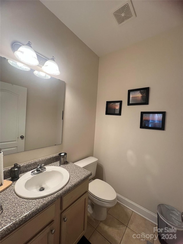 bathroom with vanity, tile patterned floors, and toilet