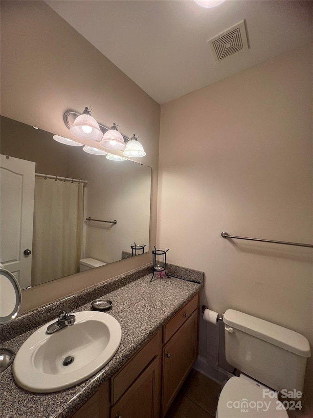 bathroom with vanity, tile patterned floors, toilet, and a shower with shower curtain