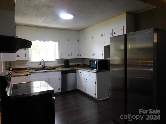 kitchen featuring a textured ceiling, stainless steel appliances, white cabinets, and sink