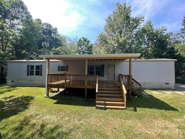 rear view of house featuring crawl space, a yard, and a wooden deck