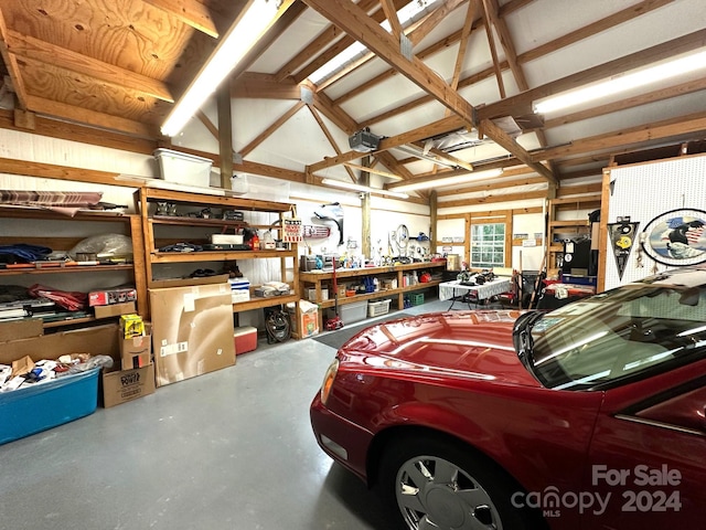 garage with a workshop area and a garage door opener